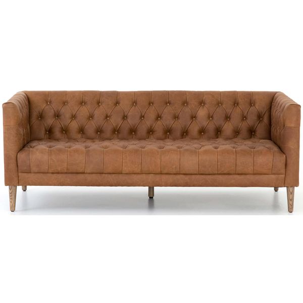 Sofa tapicerowana o spokojnej linii z dopracowana sylwetka w odcieniu brazu